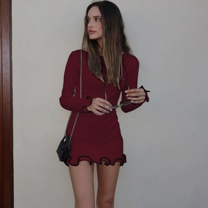 Detail of the ruffle edge design and knit texture on this sexy burgundy long sleeve dress