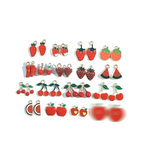 Assorted red fruit and vegetable enamel metal charms including strawberry and cherry