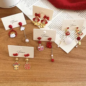 Traditional Chinese New Year lion dance earrings with red tassels and gold pearls
