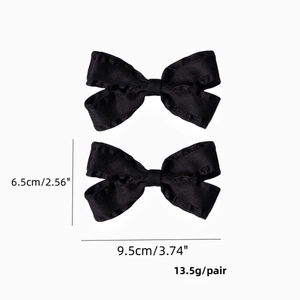 Detailed size chart for pair of black satin bow hair clips with dimensions and weight info