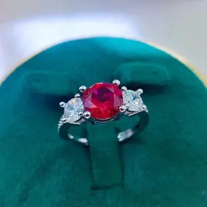 Detailed macro view of 2 carat round red ruby ring set in a luxury velvet jewelry box