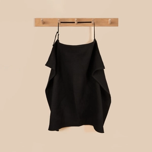 Detail of black waffle-weave cotton nursing cover with adjustable neck strap