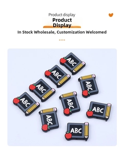 Detail of school themed PVC charms featuring blackboards, pencils, and apple shapes