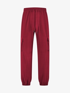 Detailed view of dark red cargo pants with textured fabric and elastic drawstring waist
