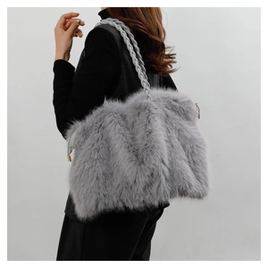 Detail of grey plush tote bag featuring soft faux fur texture and woven rope shoulder strap