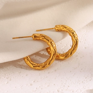 Macro detail showing irregular hammered texture on these 18K gold plated hoop earrings