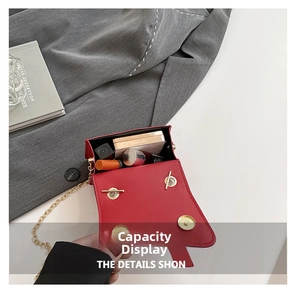 Detail view of red leather saddle bag open showing internal capacity for cosmetics