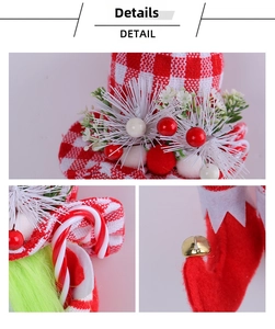 Detail view of red plaid hat, white petals, berries, and felt boots with gold bells