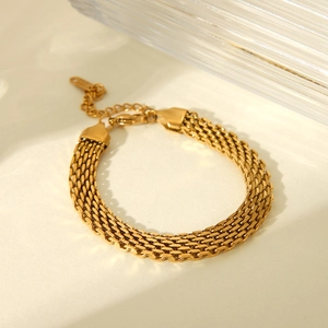 Detailed view of 18K gold plated wide watch-band style chain bracelet with woven metal texture