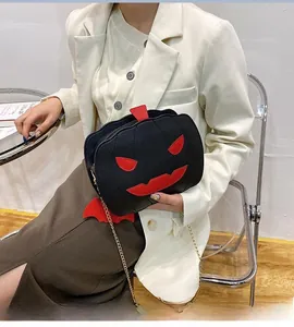 Halloween pumpkin-shaped black cross-body bag with bat wings and gold chain strap