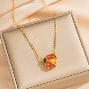 Elegant 18k gold plated stainless steel necklace with ladybird pendant on silk ribbon