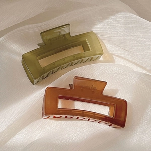 Pair of 10.5cm square hair claws in translucent dark green and amber brown resin finish
