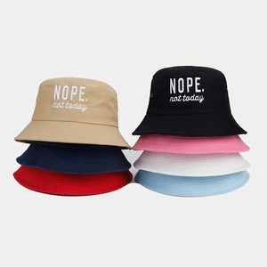 Group of cotton bucket hats in seven colors featuring NOPE embroidery detail