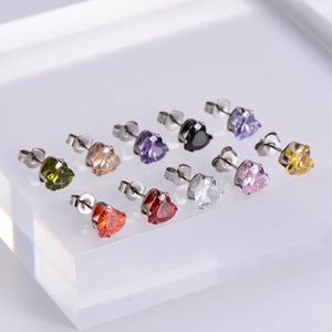 Set of ten colorful heart-shaped zircon stud earrings arranged on a clear display stand