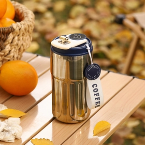 Detail view of smart coffee mug with LED temperature display on lid and white strap