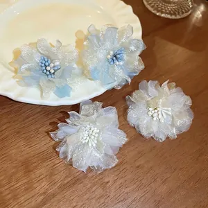 Elegant organza flower earrings with pearls and mesh petals in blue and cream white