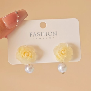 Detailed close-up of French vintage style resin flower earrings with white pearl drop