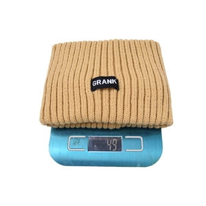 Close-up of khaki waffle knit headband on a digital scale showing 49g weight