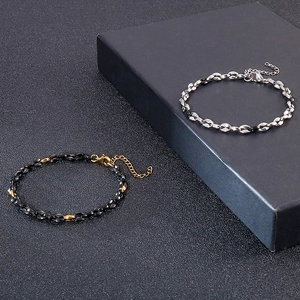Detail of silver and black stainless steel coffee bean link chains with lobster clasp