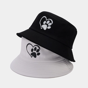 Black and white bucket hats featuring a heart and paw print logo for outdoor sun protection