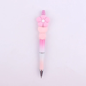 Close-up of pink daisy flower silicone bead and gradient pink plastic beaded pen