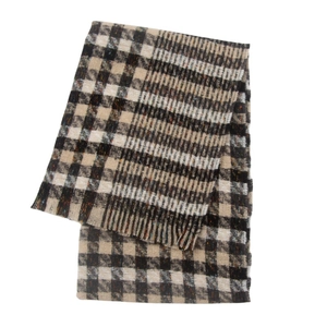 Detailed close-up of plaid scarf texture in black and beige with fine fringe edges
