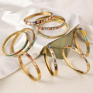 Detailed view of colorful enamel floral patterns on 18K gold plated bangle jewelry