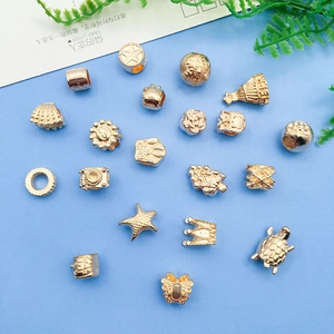 Detail view of 22 pieces rose gold alloy beads with starfish and crown shapes