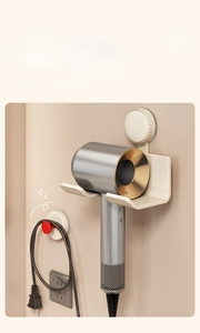 Detail view of wall-mounted hairdryer holder with cord organizer in creamy white finish
