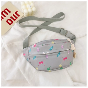 Detail of grey kids waist bag with cartoon prints, green strap and rabbit zipper pull