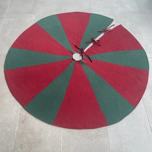 Detailed close-up of knitted red and green striped 48-inch Christmas tree skirt with ties