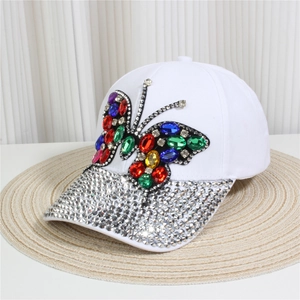Close-up of a white denim baseball cap featuring a colorful rhinestone butterfly and shiny brim