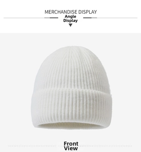 Detailed close-up showing the thick ribbed texture and rolled cuff of the white knit beanie