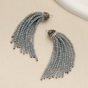 Detail of grey beaded tassel charms with rhinestone caps and small rings for jewelry DIY