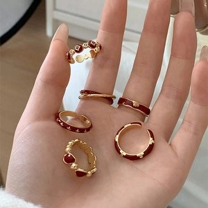 Detailed macro view of vintage gold ring set with deep red enamel floral motifs