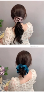 Detailed texture of soft silk satin scrunchies in dusty rose and blue shades