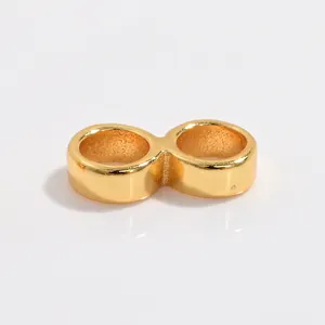 Detailed close-up of golden S925 sterling silver infinity link connector for DIY jewelry