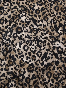 Close-up detail of vintage leopard print pattern on quilted cotton fabric texture