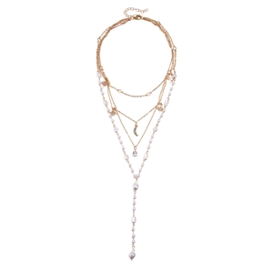 Layered gold star and moon necklace with faux pearls and teardrop pendant in chic style
