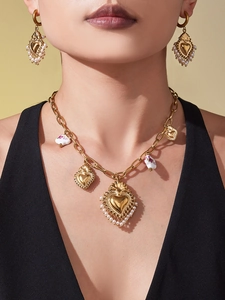 Détail du collier cœur en or 18k avec perles blanches et pendentif couronne baroque