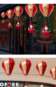 Detail of red and gold Christmas hot air balloon hanging decor with Santa Claus doll