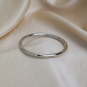 Minimalist high-polished hollow stainless steel bangle with reflective mirror finish