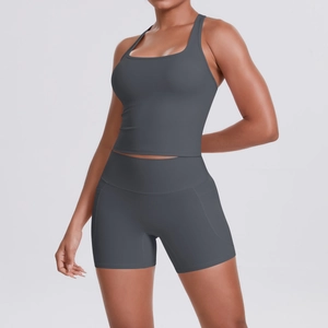 Detail view of dark grey racerback yoga top and high waist shorts with side pockets