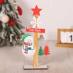 Detailed view of festive wooden Christmas tabletop decor with snowman and holiday greetings