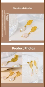 Macro detail of leaf-shaped gold titanium earrings with natural baroque pearls