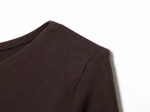 Macro view of dark brown knit fabric neckline with detailed stitching texture