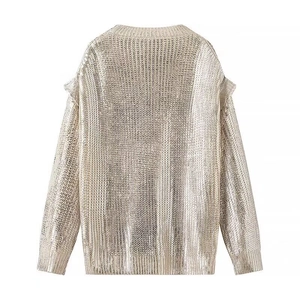 Women's gold metallic knit sweater with crew neck, ruffle trim, and cutout shoulders