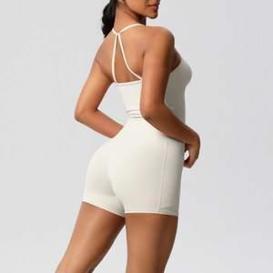 Detail of high-waist cream yoga bodysuit featuring criss-cross back straps and side pockets