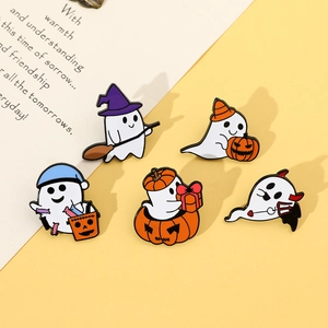 Detail of five Halloween enamel pins featuring ghosts, pumpkins, and wizard hats on a card