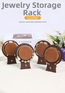 Close-up of walnut wood jewelry display trays with soft brown velvet inserts and bracelets